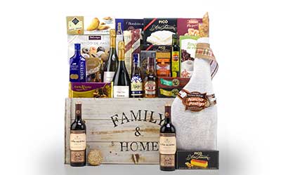 family basket with ham, bottles of liquor and sweets.