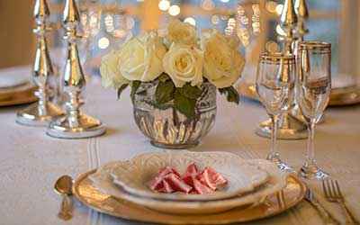 slices of ham on a plate on a very elegant table.